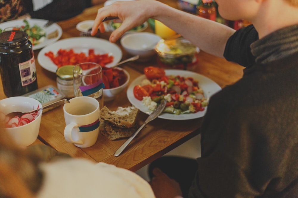 person in front of table with salsa dish