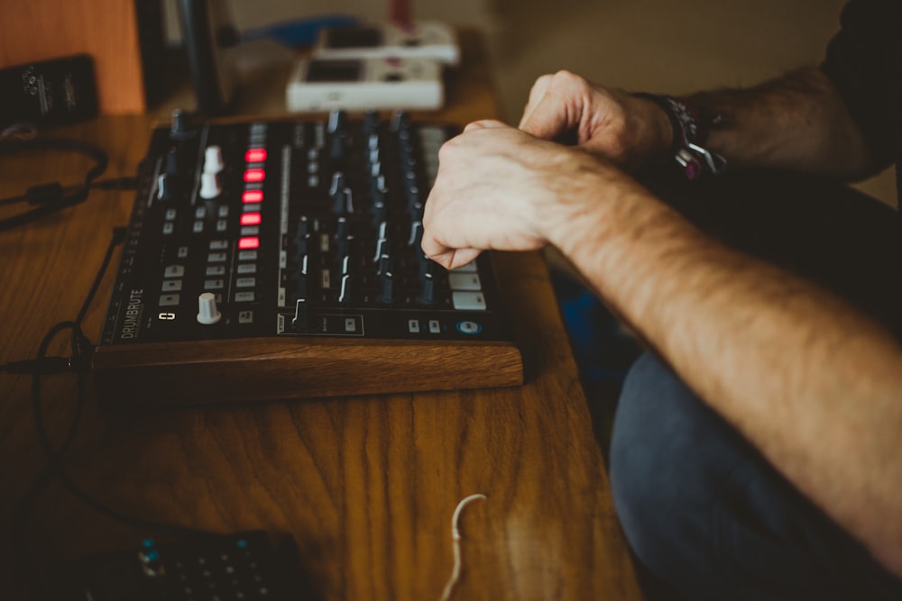 person playing audio interface inside well-lit room