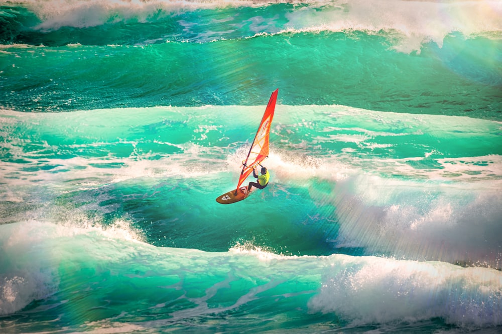 man using wind surfboard during daytime