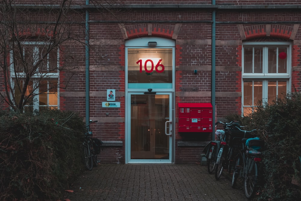 two black bicycles in front of clear glass door