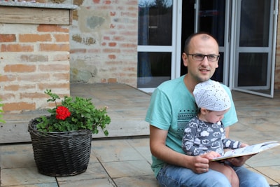 A caring parent and child reviewing an investment booklet at a sunny kitchen table.