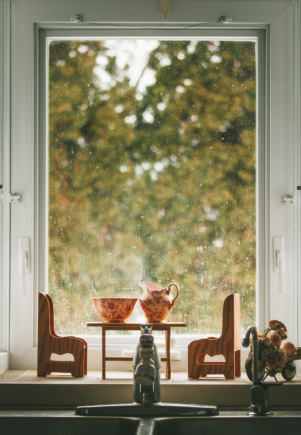 miniature chairs and table near window