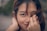 selective focus photography of woman covering her face