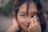 selective focus photography of woman covering her face