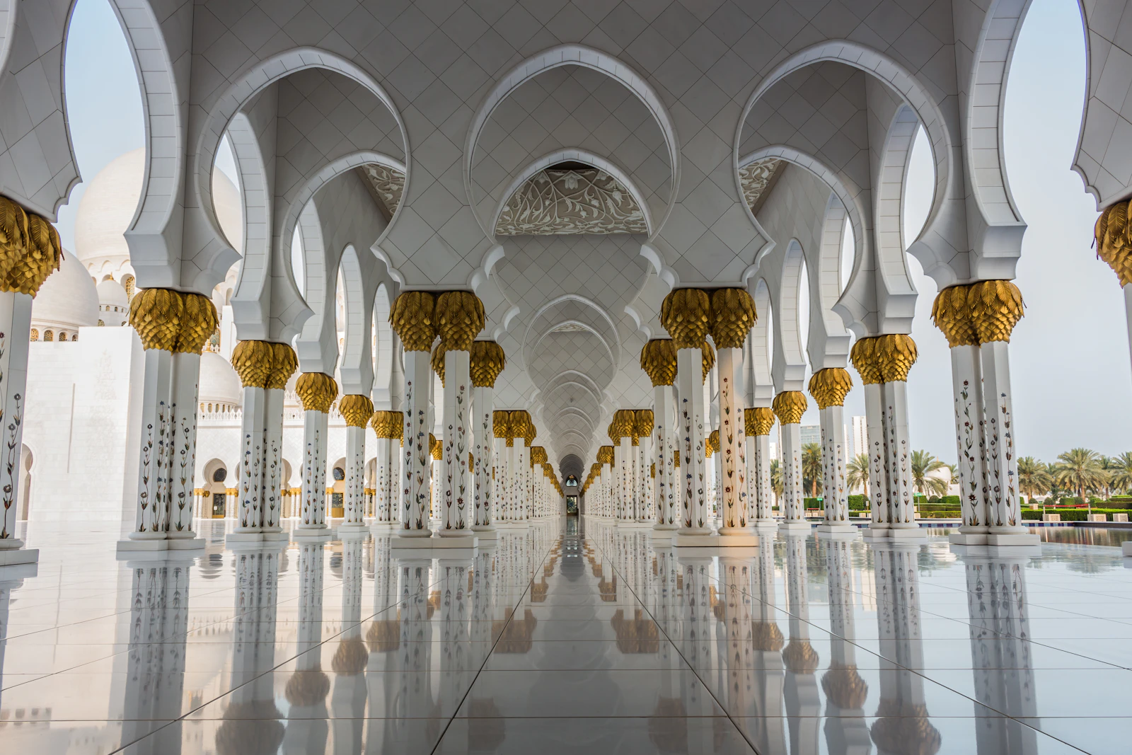 Symmetrical white colonnade at Sheikh Zayed Grand Mosque