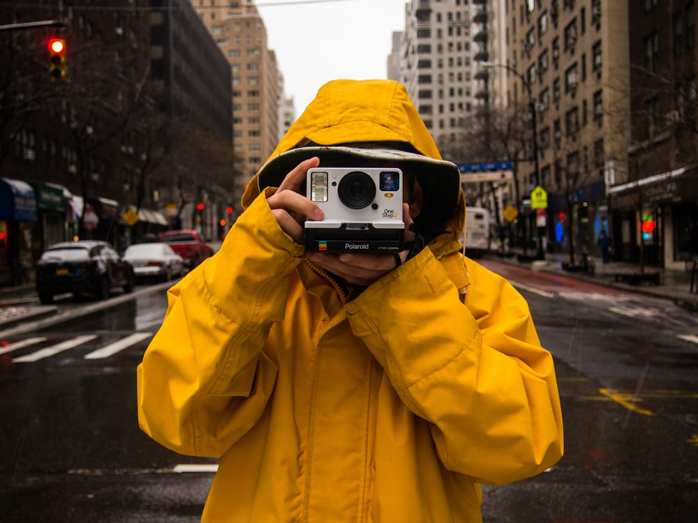 person holding instant camera