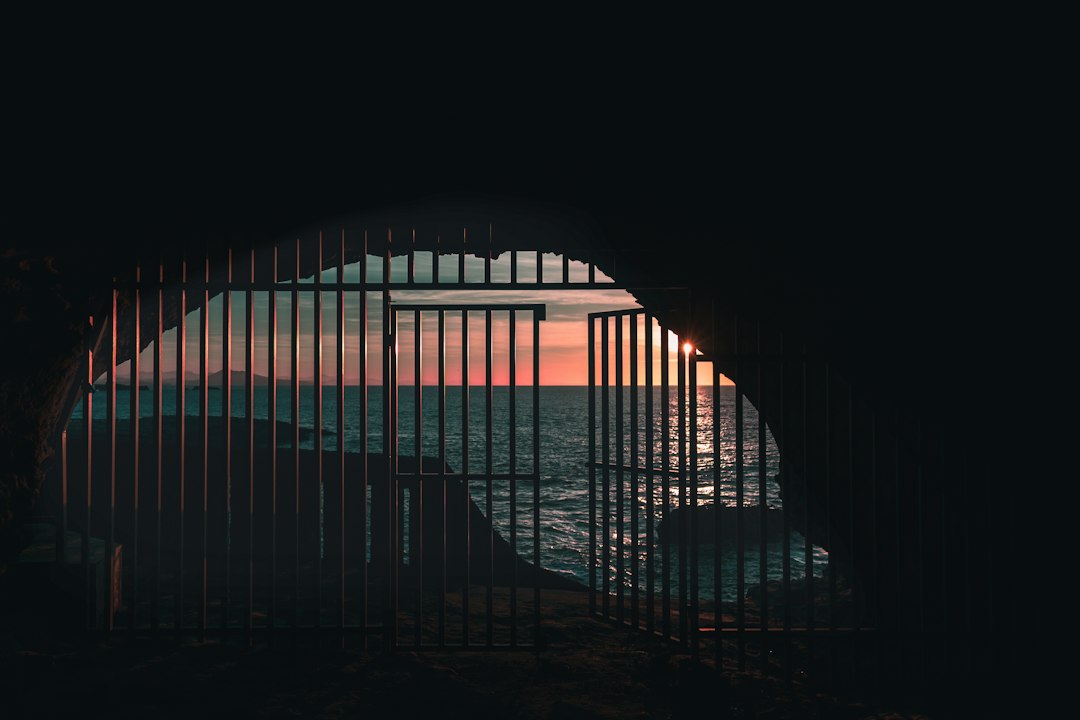 opened gate near body of water, Instagram: alban.martel