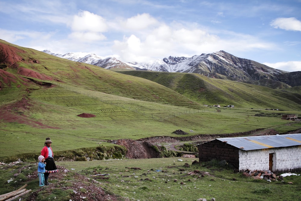 a person standing in a field with mountains in the background