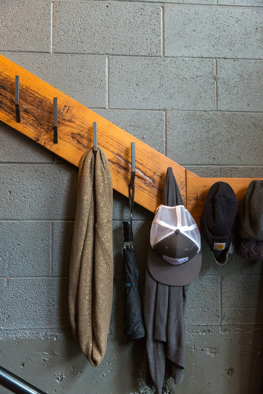 brown scarf hanging on brown rack