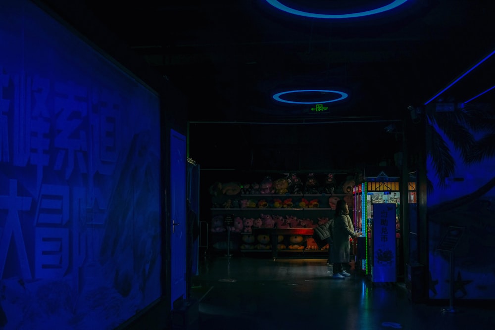 man in front of plush toy claw machine