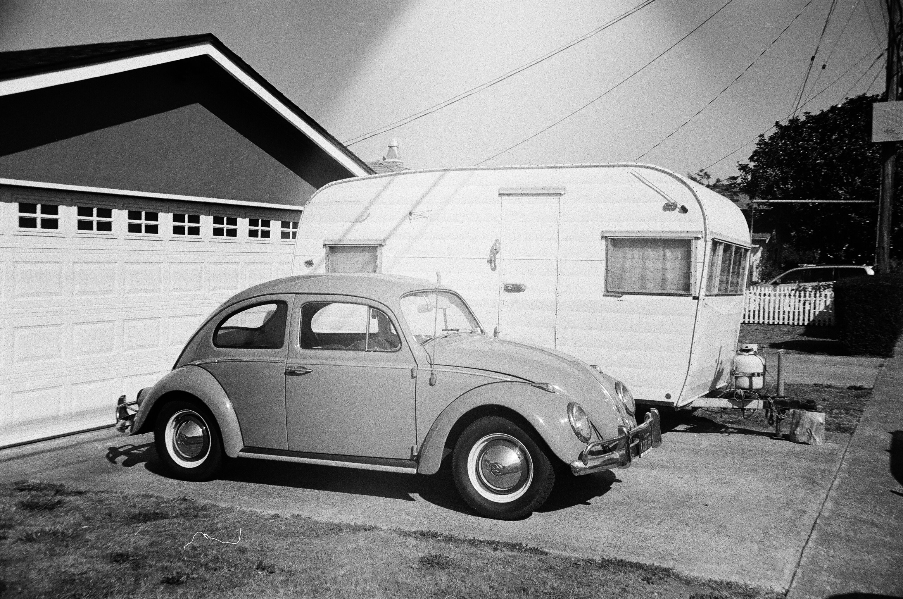 On the driveway of a Pacifica, CA home is a timeless collection of car and camper. Shot on film with a Nikon FE2.