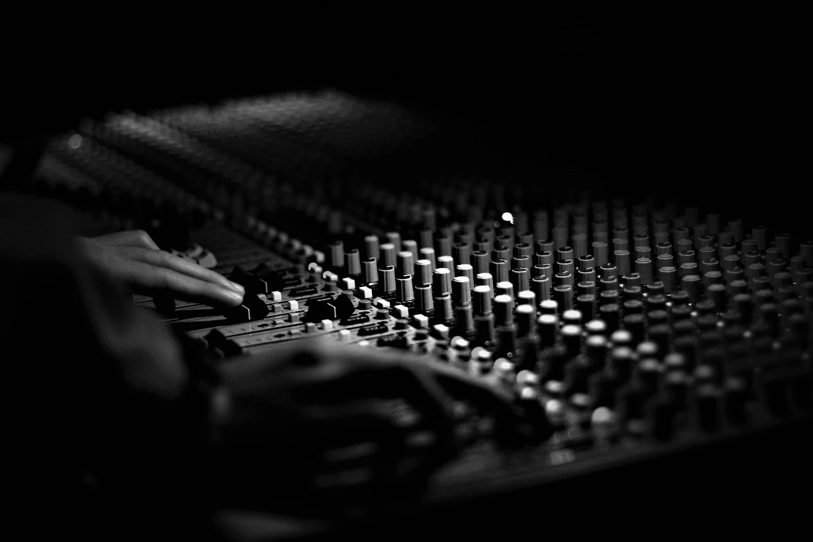Moody grayscale mixing console in low light