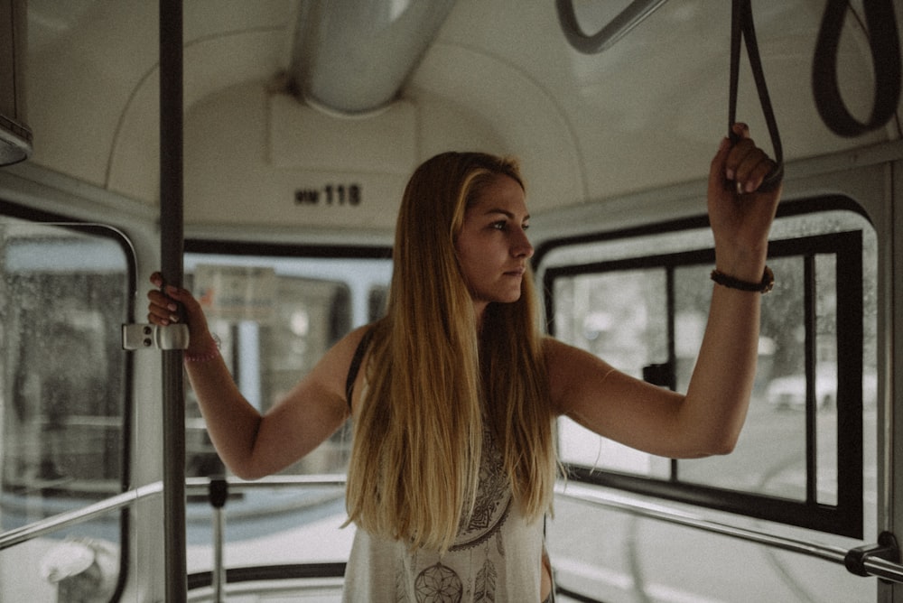 woman holding gray metal pole