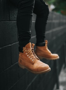 person wearing pair of brown Timberland leather work boots