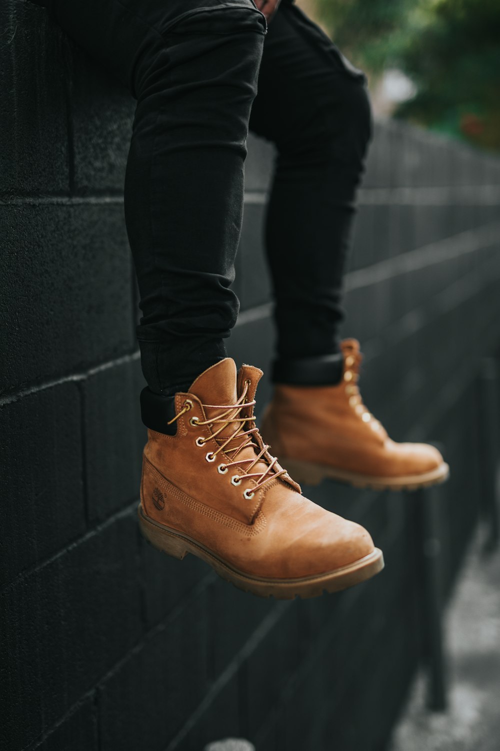 person wearing pair of brown Timberland leather work boots