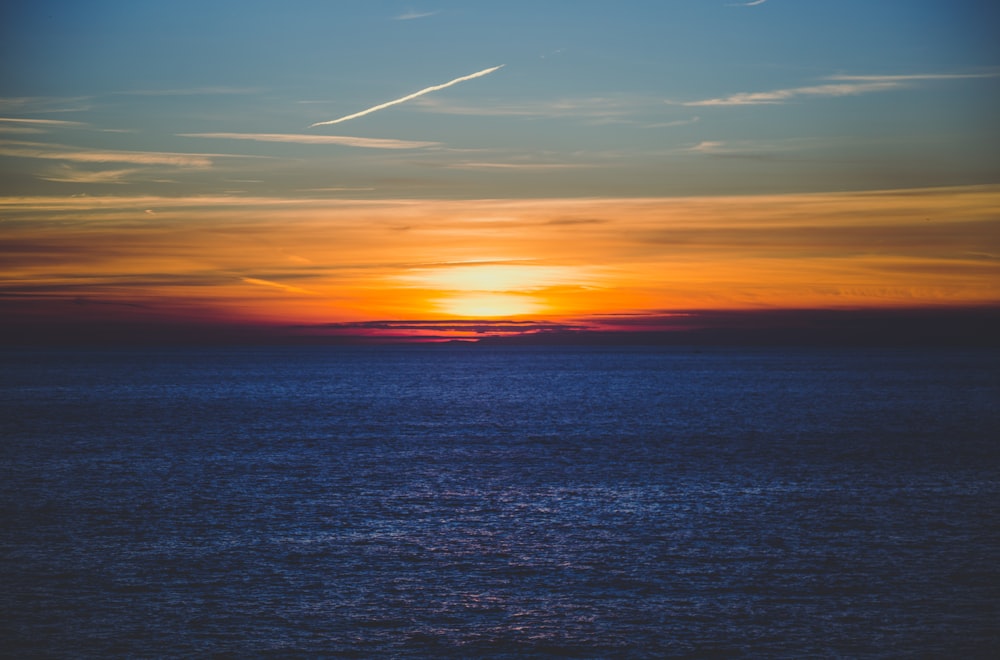 aerial photography of sea over sunset