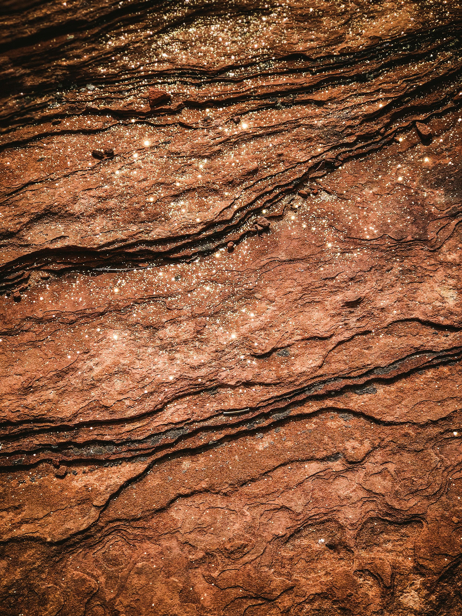a close up of a rock surface with water