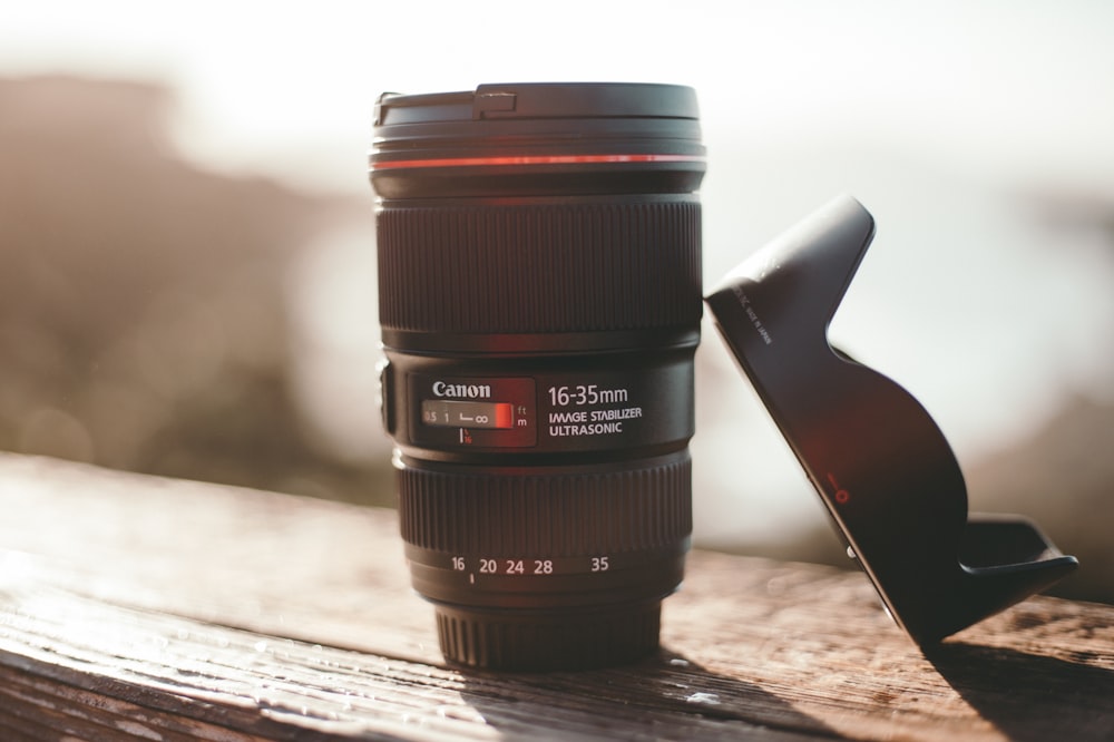 black camera lens on brown wooden table