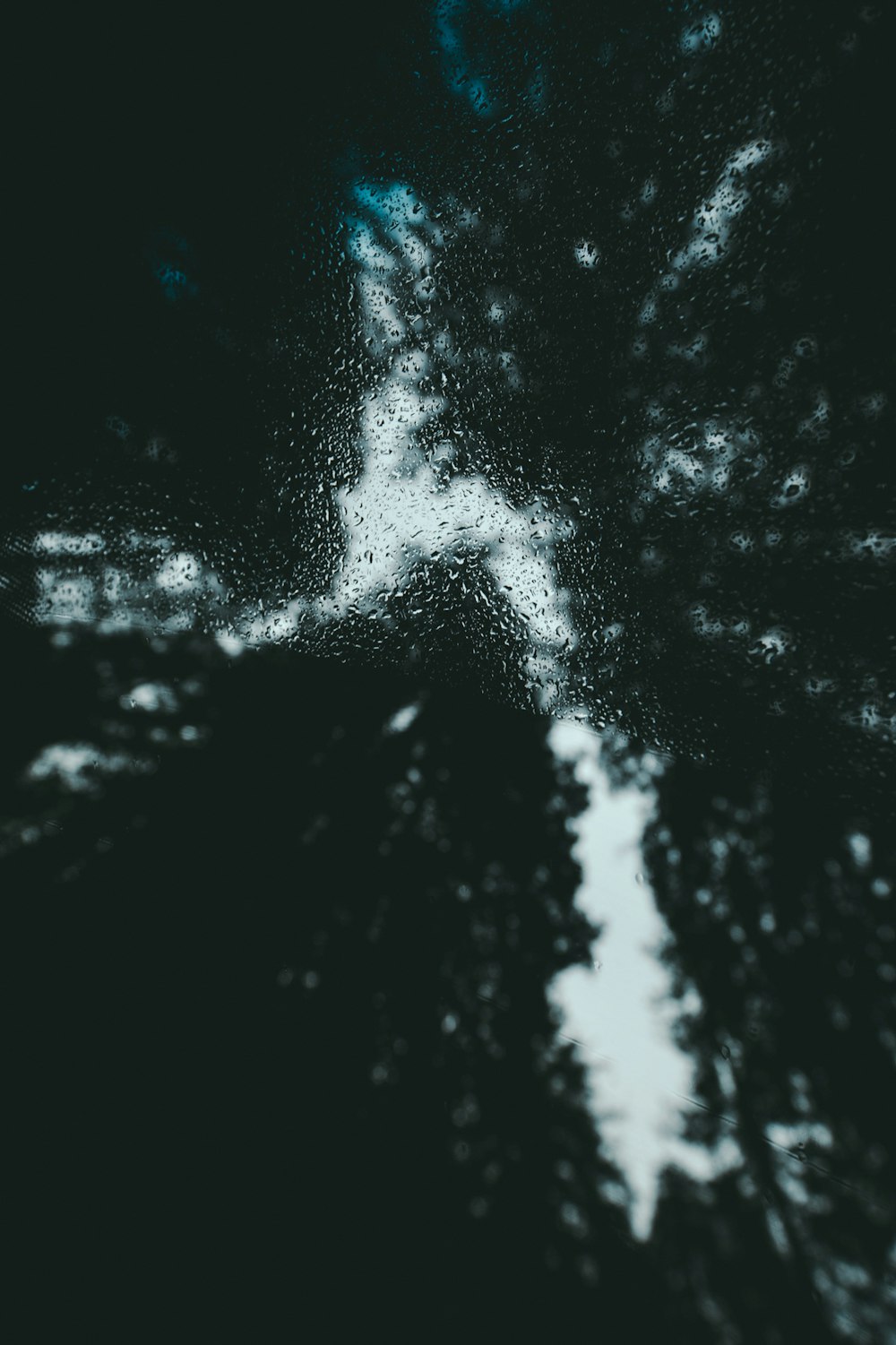 a black and white photo of a cross in the sky