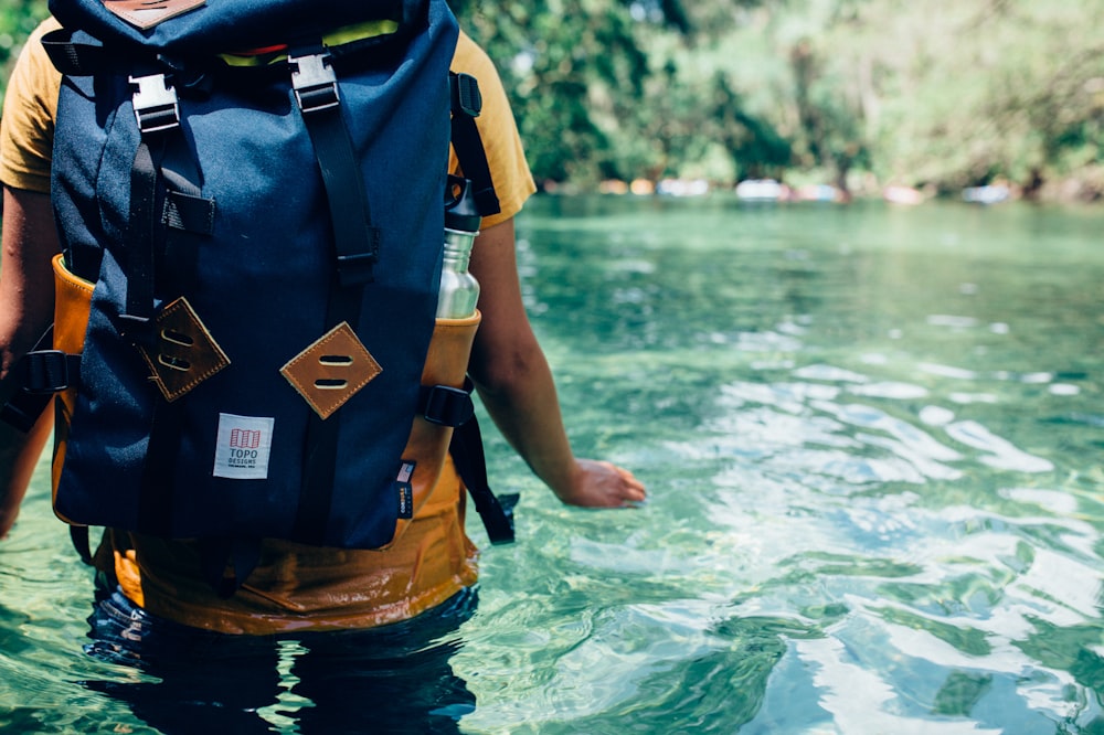 person crossing the river during daytime