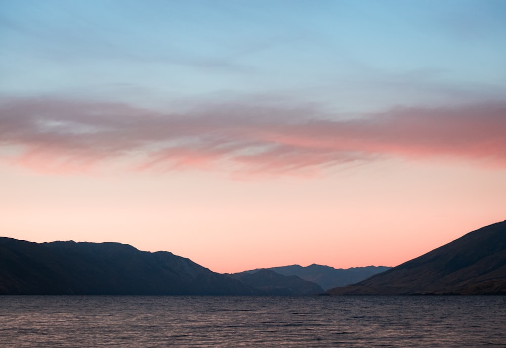 mountains near body of water