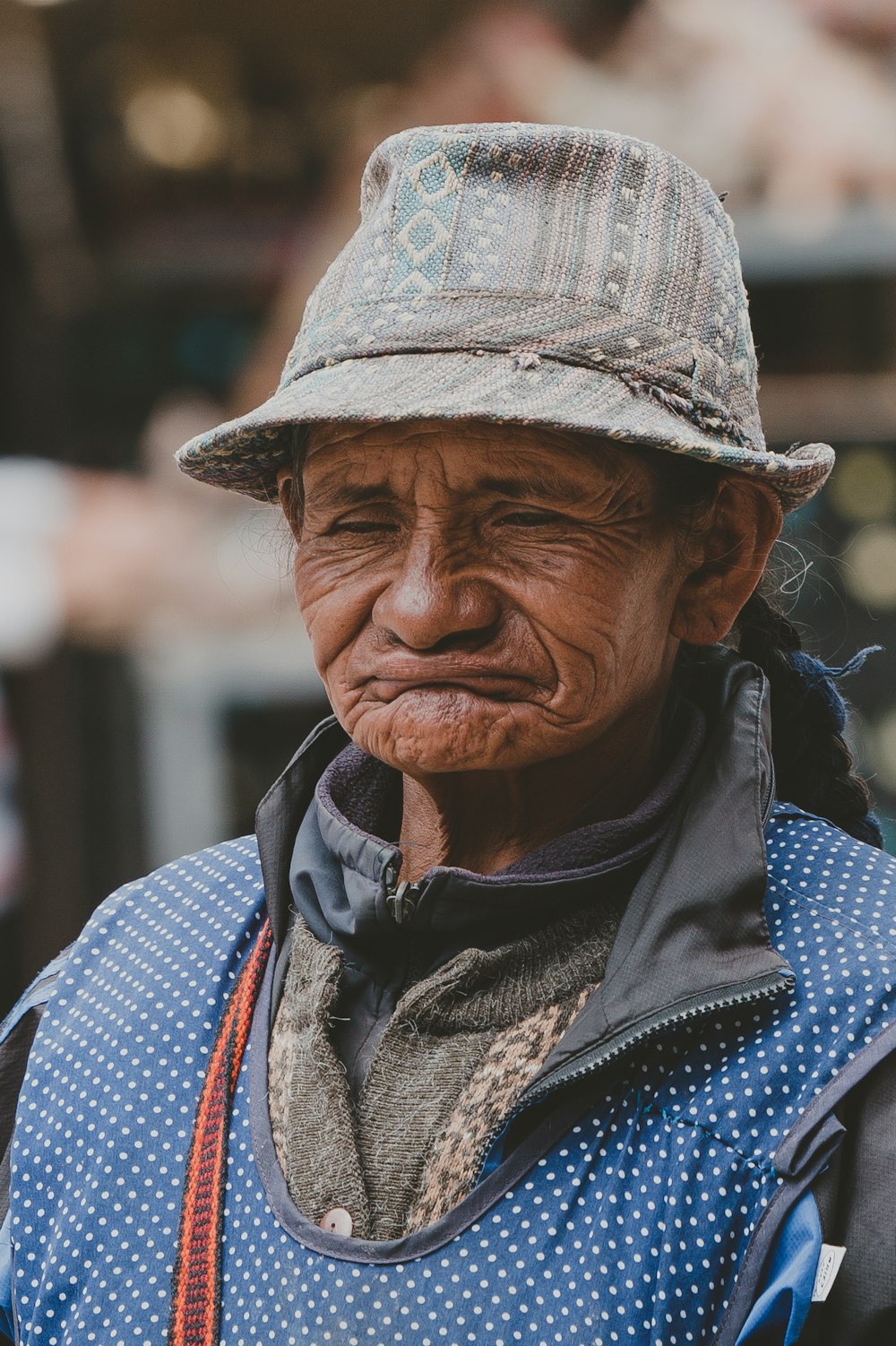 person wearing cat and blue vest focus photo