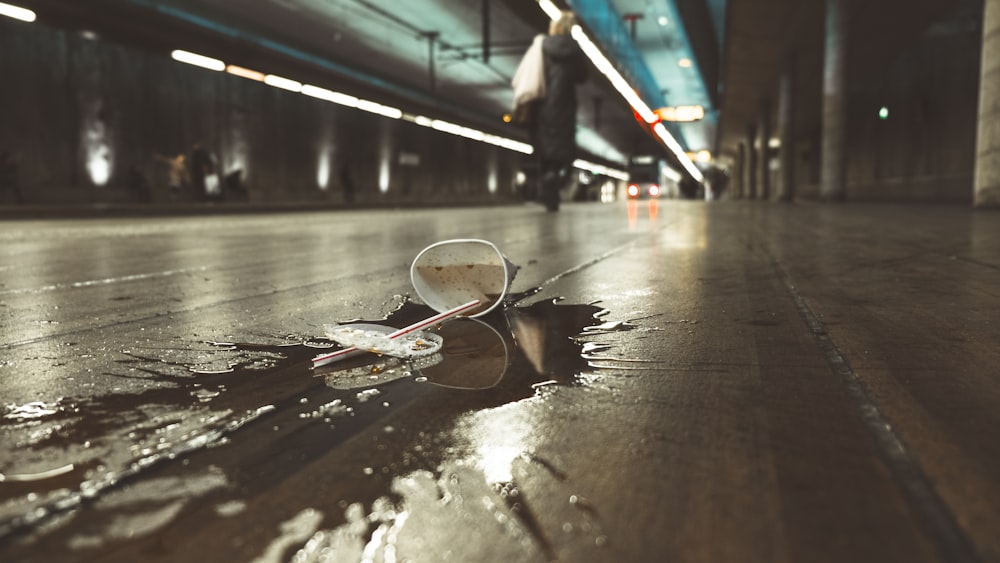white paper cup spilled on road