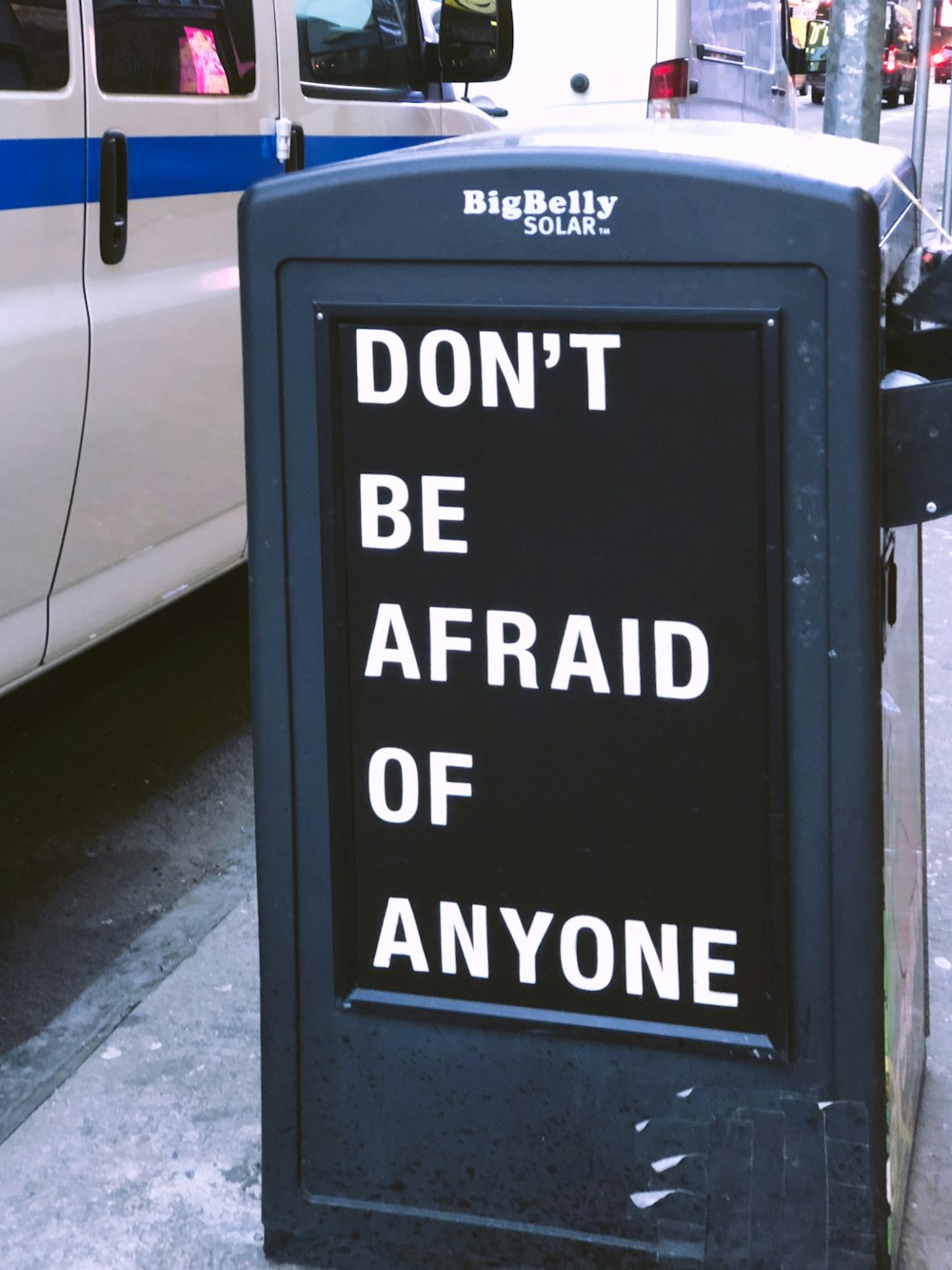 Don't be afraid of anyone sign near vehicle during daytime