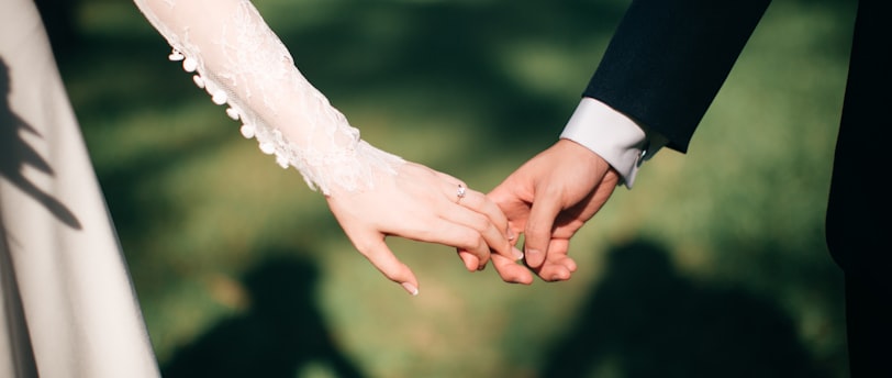 man and woman holding hands focus photo