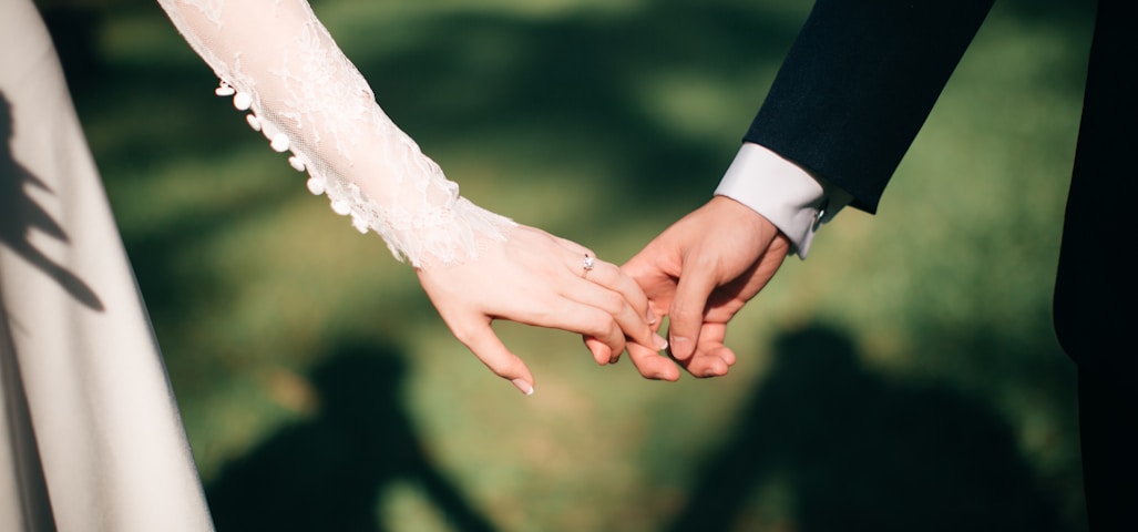 man and woman holding hands focus photo