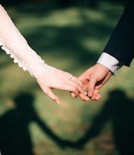 man and woman holding hands focus photo