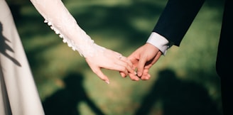 man and woman holding hands focus photo