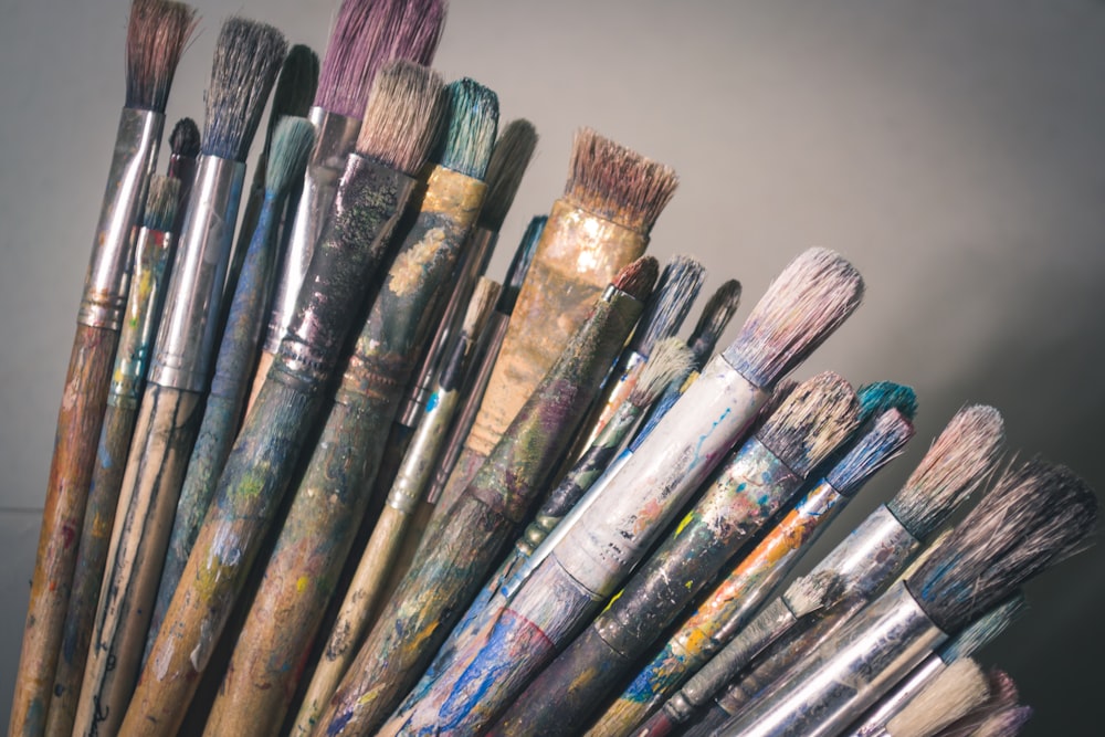 A glass vase filled with purple and white makeup brushes photo – Free Grey  Image on Unsplash