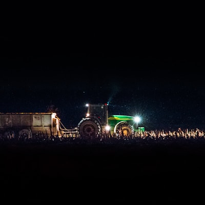 green freight truck on land during night