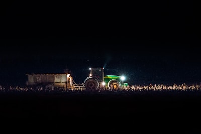 green freight truck on land during night