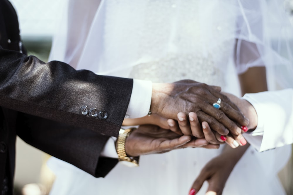 man holding hands white wearing silver-colored ring