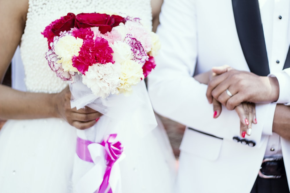 woman holding red and white flower bouquet