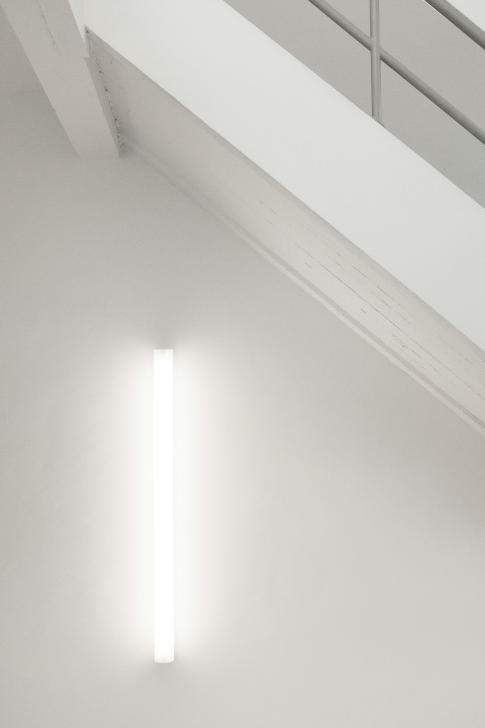 a white room with a light on the wall