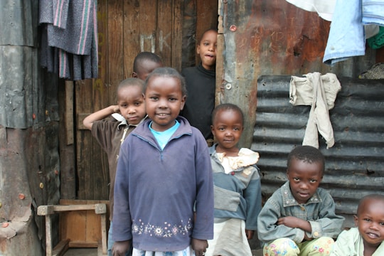 A group of Ethiopian children happily gathered around a newly built classroom in a rural village.