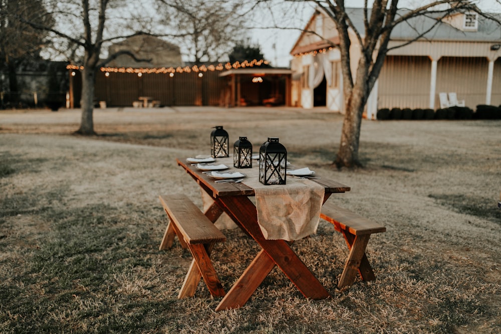 rectangular brown wooden picnic table on the field