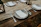 Rustic dinner plate on a wooden table set with fresh food and cozy linen napkins.