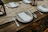 Rustic dinner plate on a wooden table set with fresh food and cozy linen napkins.