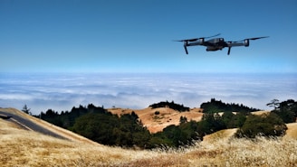 black drone on air over cloudy sky at daytime