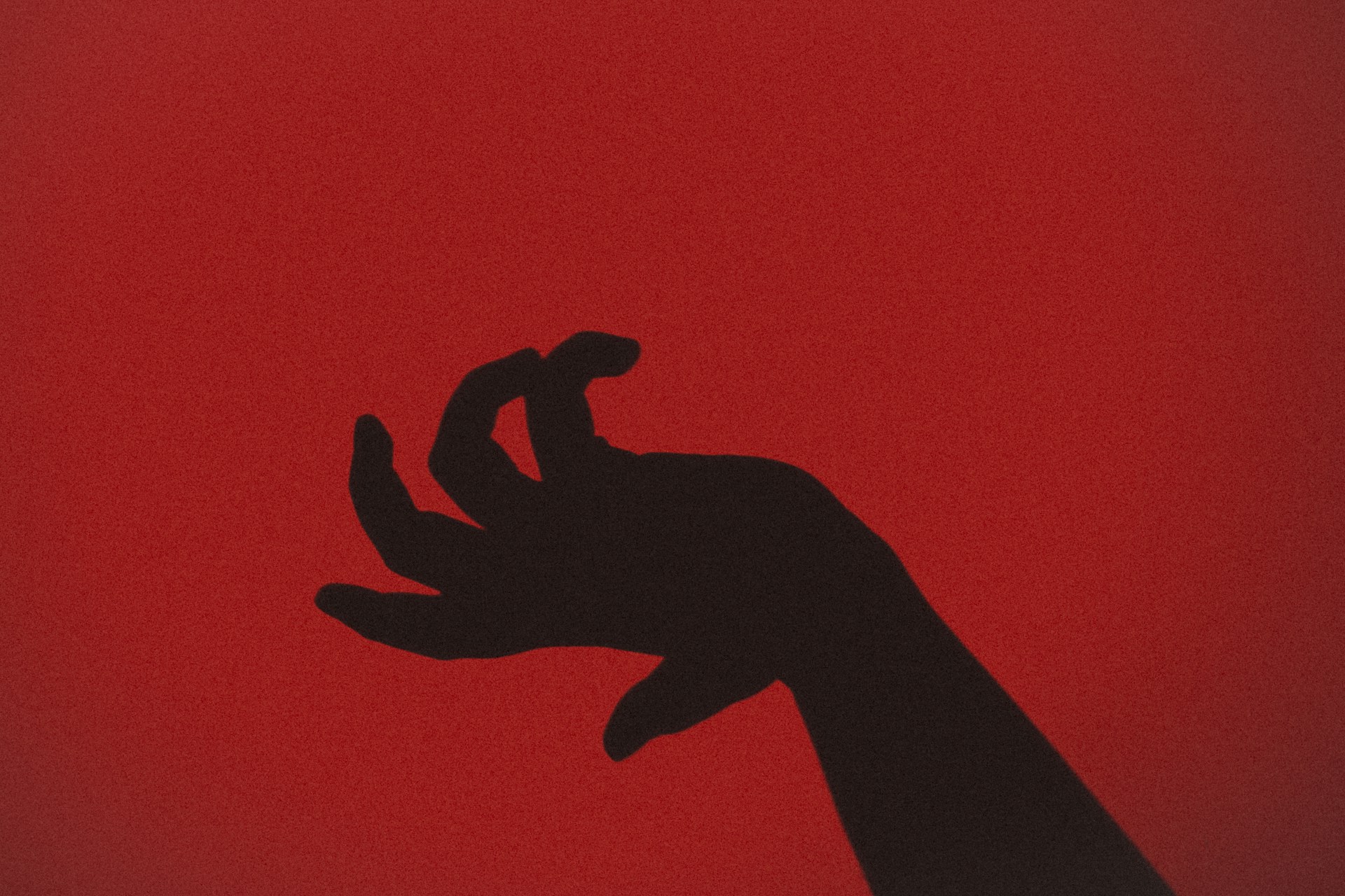 silhouette of hand with red background