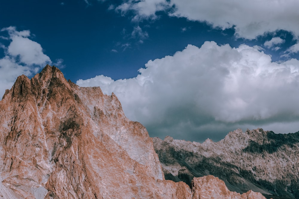 brown rock formations under white clouds at daytime