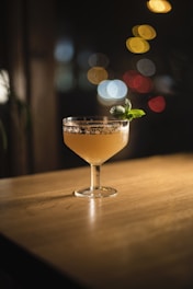 clear cocktail glass on brown wooden table