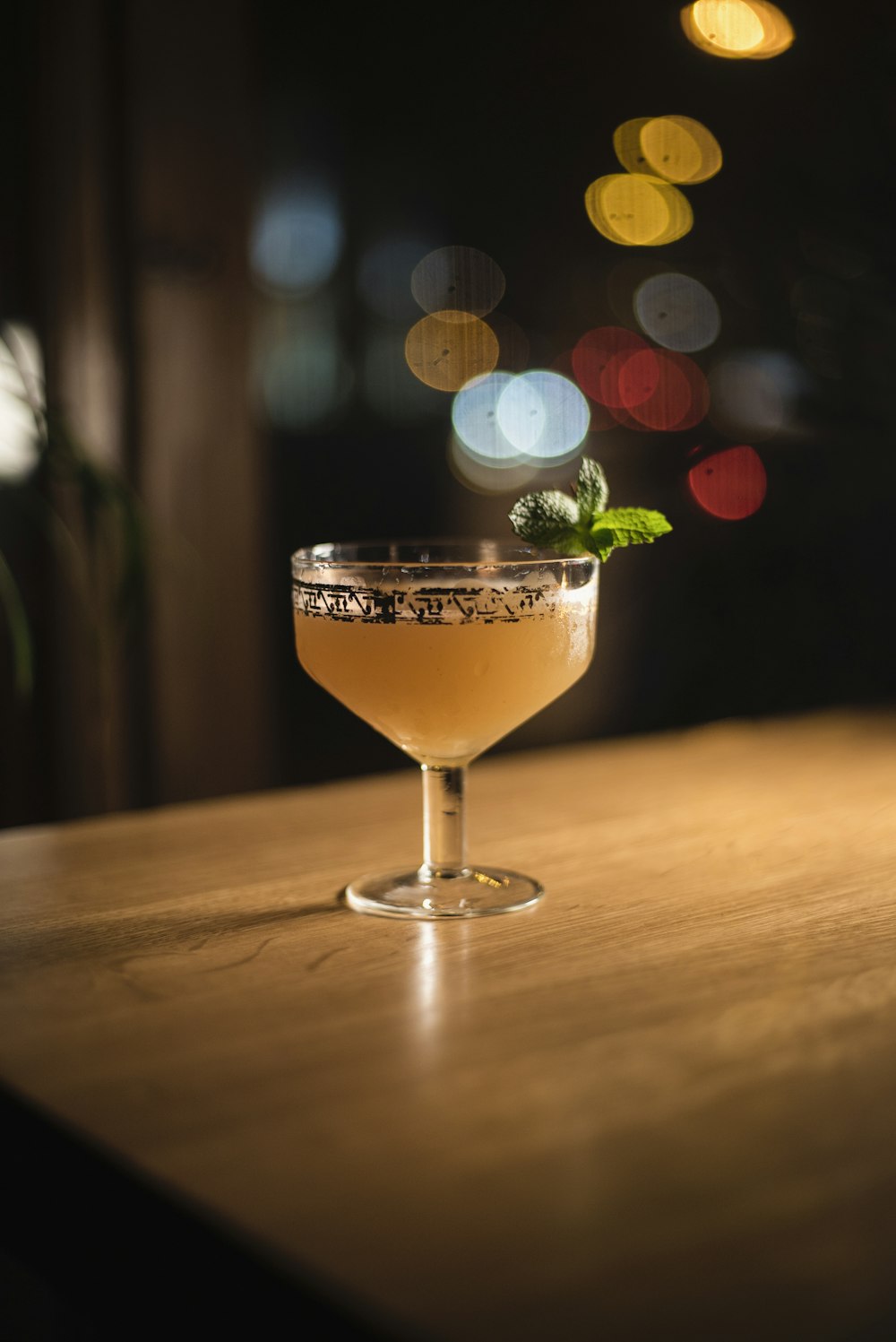 clear cocktail glass on brown wooden table