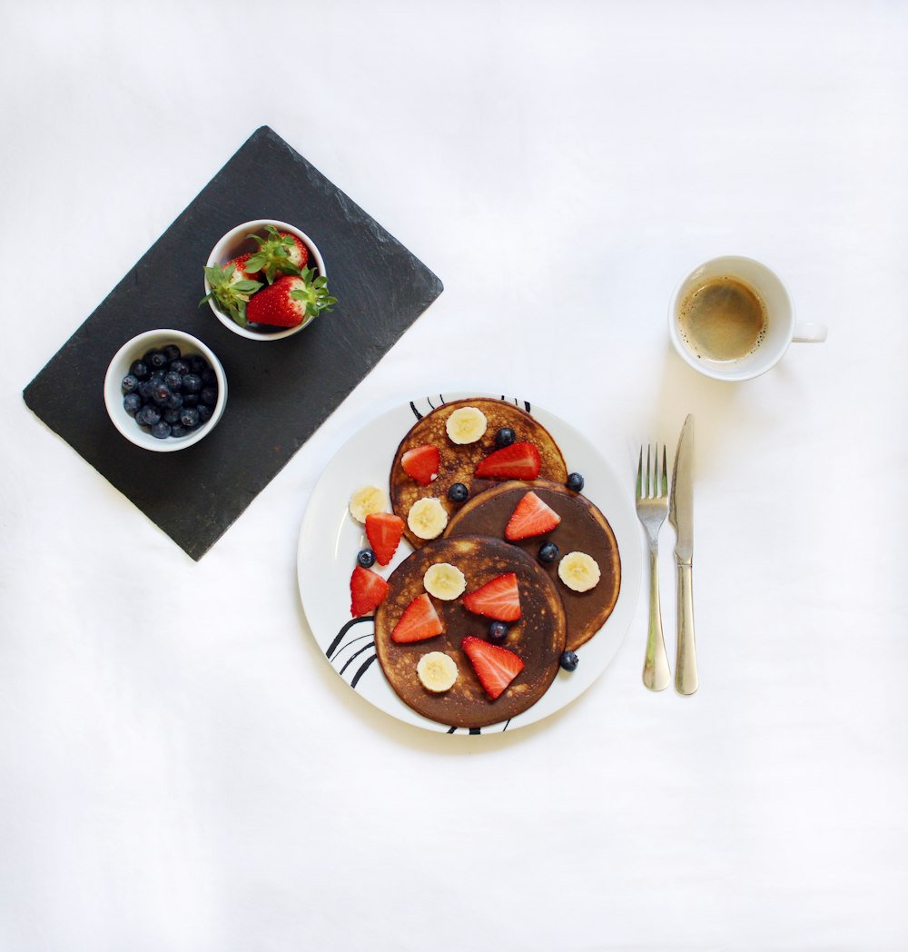flat-lay photograph of pancakes and coffee in mug