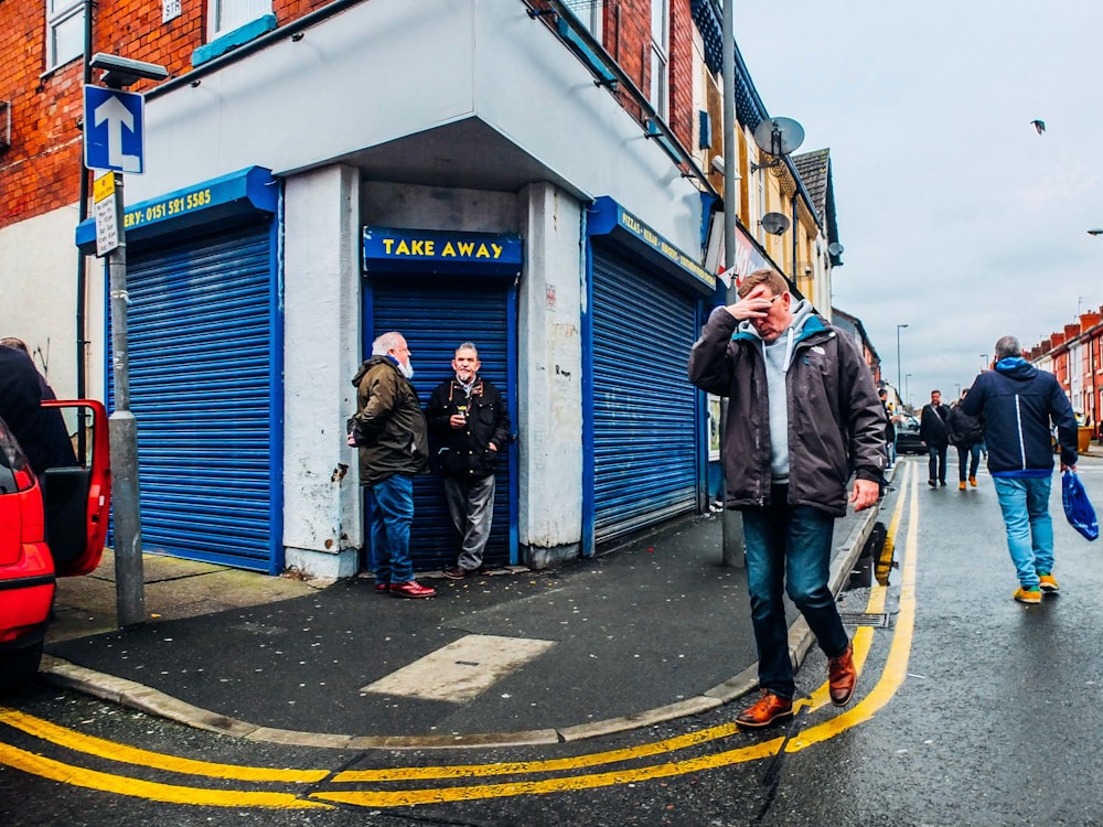 street photography of man walking on sidewalk