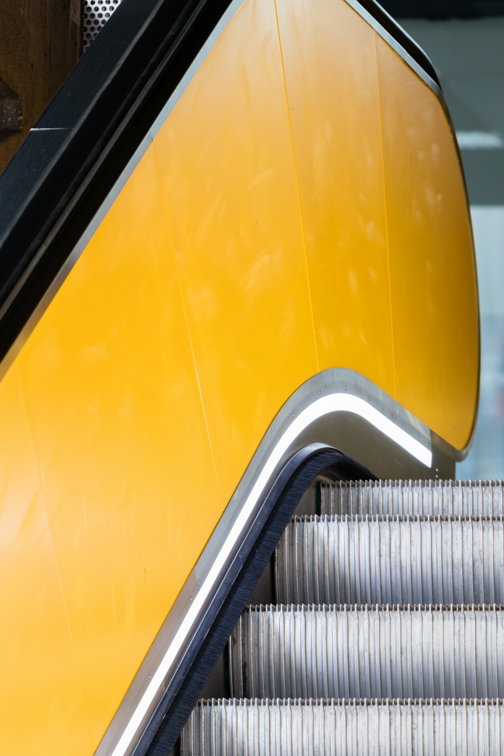 an escalator with a yellow and black color scheme